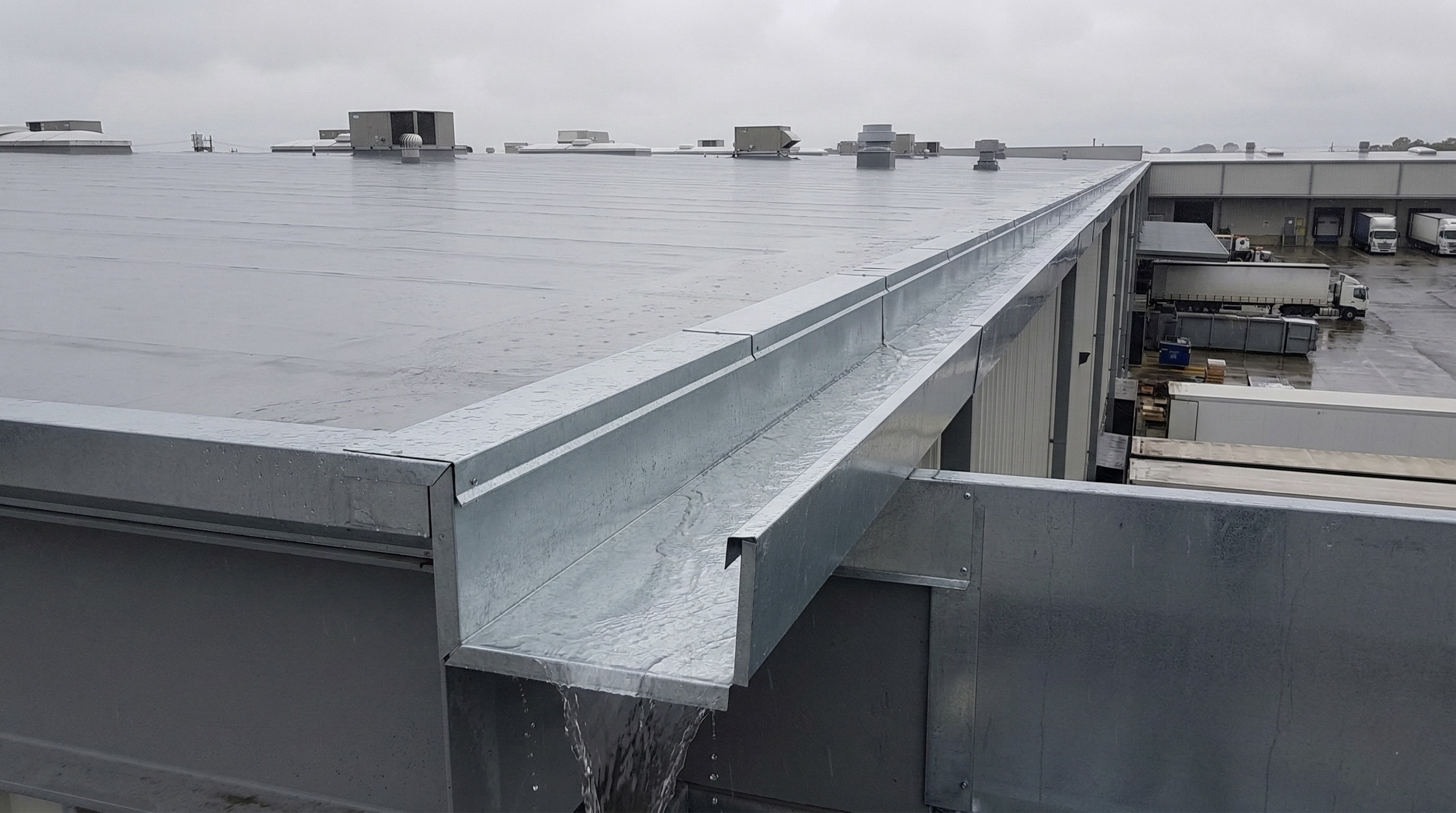 Commercial-grade galvanized steel gutter system for roof drainage